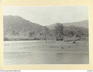 DANMAP RIVER, NEW GUINEA. 1945-01-05. A SECTION OF HEADQUARTERS, 6TH DIVISION LOOKING SOUTH UP THE RIVER AND TAKEN FROM THE WEST BANK AT THE MOUTH. IN THE BACKGROUND CAN BE SEEN THE TORRICELLI ..