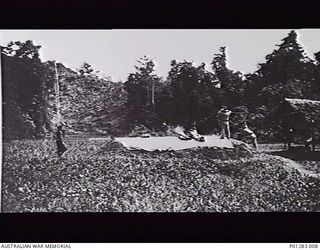 SALAMAUA, NEW GUINEA, 1940-04-?. MEMBERS OF THE NEW GUINEA VOLUNTEER RIFLES (NGVR) AT MACHINE GUN PRACTICE WITH A LEWIS MK 1 MACHINE GUN ON THE RIFLE RANGE. (DONOR H. WALTER)