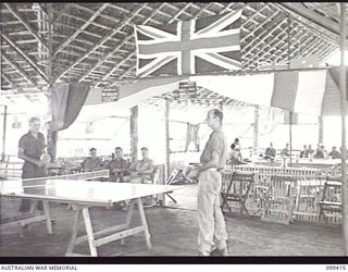 RABAUL, NEW BRITAIN, 1945-12-12. THE INTERIOR OF THE YMCA-SALVATION ARMY RECREATION HUT AT 28TH INFANTRY BATTALION, SHOWING THE PING PONG TABLE AND THE COMFORTABLE FURNISHINGS