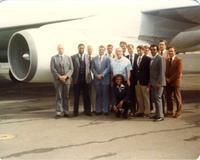 Claude Pepper with group of men and flight attendant in front of a plane