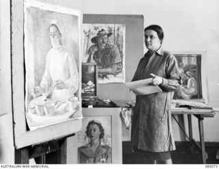 Captain Nora Heysen, Official War Artist, Military History Section, in her studio at 138 Flinders Street completing paintings which were commenced in New Guinea