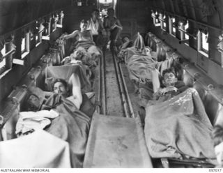 NADZAB AIRSTRIP, NEW GUINEA. 1943-09-18. WOUNDED AUSTRALIAN SOLDIERS ON STRETCHERS IN AN AIRCRAFT ABOUT TO TAKE OFF FOR PORT MORESBY