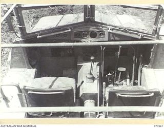 MADANG - ALEXISHAFEN ROAD, NEW GUINEA. 1944-05-26. THE COCKPIT CONTROLS OF A JAPANESE ARMOURED TRACTOR, WHICH WAS ABANDONED ON THE ROAD NEAR MILILAT PLANTATION. DESIGNED TO SEAT APPROXIMATELY 7 ..