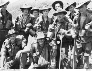 KUMBARUM, NEW GUINEA. 1943-11-30. INFANTRY MEN OF THE 2/31ST AUSTRALIAN INFANTRY BATTALION, JUST ARRIVED AT CAMP AFTER A LONG MARCH FROM THEIR FORWARD POSITIONS IN THE FINISTERRE RANGES. SHOWN ARE: ..