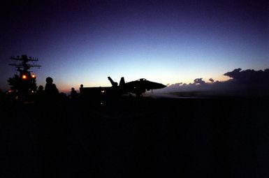 As the sun sets, flight operations on the nuclear-powered aircraft carrier USS CARL VINSON (CVN-70) are just warming up as an F-18 Hornet crew participates in the exercise RIMPAC 98