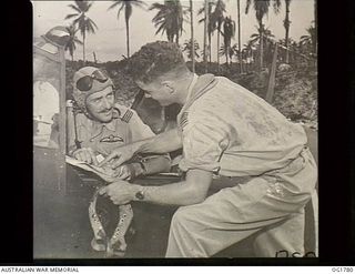 MOMOTE, LOS NEGROS ISLAND, ADMIRALTY ISLANDS. C. 1944-03. SQUADRON LEADER IAN LOUDON, THE COMMANDING OFFICER OF NO. 76 (KITTYHAWK) SQUADRON RAAF WITH HELMET IN HAND AND WEARING HIS MAE WEST ..