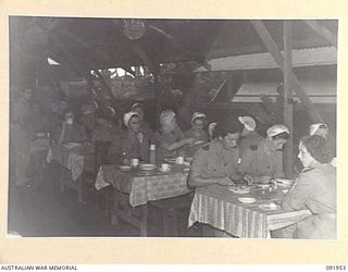 TOROKINA, BOUGAINVILLE, 1945-04-18. MEMBERS OF AUSTRALIAN ARMY NURSING SERVICE FROM 2/1 GENERAL HOSPITAL HAVING BREAKFAST IN THE SISTERS MESS