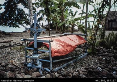 Grave, South Normanby. A recent grave near Dawatai, protected by plastic sheeting from mining camp