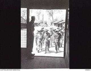 TOROKINA, BOUGAINVILLE, 1945-10-27. A GROUP OF STUDENTS OF THE TOROKINA REHABILITATION TRAINING CENTRE, READY TO USE THE CENTRAL REFERENCE LIBRARY. SERGEANT R. ERICKSON, THE LIBRARIAN, OPENS THE ..