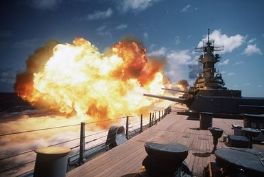 The battleship USS MISSOURI (BB-63) fires several of its Mark 7 16-inch 50-caliber guns while underway off the coast of Hawaii during Exercise RimPac '88