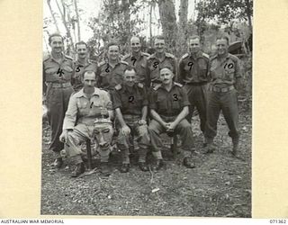 GUSIKA, NEW GUINEA, 1944-03-17. OFFICERS OF THE 1ST TANK BATTALION, ON THE WAREO TRACK. LEFT TO RIGHT: FRONT ROW: NX564 MAJOR E.J. RYRIE, WITH NATIVE MASK; NX113774 LIEUTENANT COLONEL E. A. ..