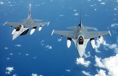 An air-to-air top front view of an F-16 Fighting Falcon aircraft in preparation for refueling, taken from a KC-135 Stratotanker aircraft during a flight from March Air Force Base, Calif., to Hickam Air Force Base, Hawaii