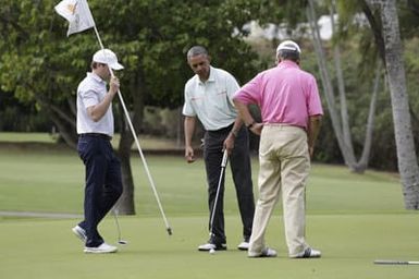Barack Obama plays golf with Prime Minister Najib Razak, Joe Paulsen, and Mike Brush in Kaneohe Bay, Hawaii, December 24, 2014