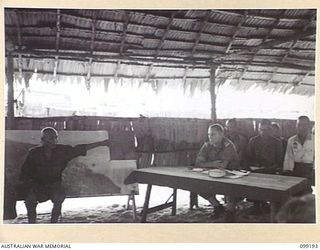 CAPE WOM, NEW GUINEA, 1945-12-01. SCENE AT THE TRIAL OF JAPANESE LIEUTENANT TAZAKI, WHO WAS CHARGED WITH AND LATER SENTENCED TO DEATH FOR CANNIBALISM, MUTILATING AND EATING THE FLESH OF AN ..