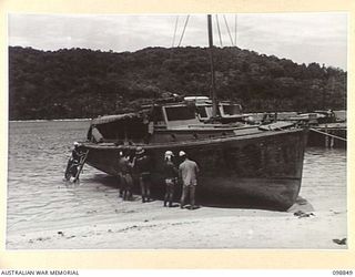 FAURO ISLAND, BOUGAINVILLE AREA. 1945-11-11. 2. JAPANESE WORKING PARTY SCRAPING PAINT FROM A CRAFT OF AUSTRALIAN WATER TRANSPORT UNIT, ATTACHED 7 INFANTRY BATTALION