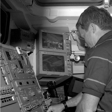 STS-49 MS Hieb works at a workstation on the flight deck of OV-105