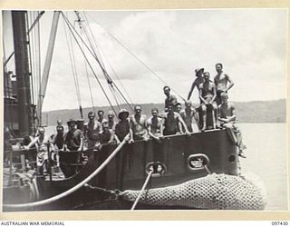 RABAUL, NEW BRITAIN. 1945-09-30. THE CREW OF THE CAMBRIAN SALVOR, SALVAGE SHIP OPERATED BY COMMONWEALTH SALVAGE BOARD. THE MEN ARE ON THE BOW OF THEIR SHIP. THEY ARE CURRENTLY WORKING ON THE ..