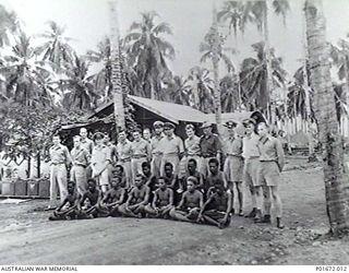 LUNGGA, GUADALCANAL, SOLOMON ISLANDS, 1944-02-29. A GROUP OF OFFICERS, OTHER RANKS AND NATIVE HOUSEBOYS AND GARDENERS AT THE HEADQUARTERS CAMP OF THE DEPUTY SUPERVISING INTELLIGENCE OFFICER (DSIO), ..