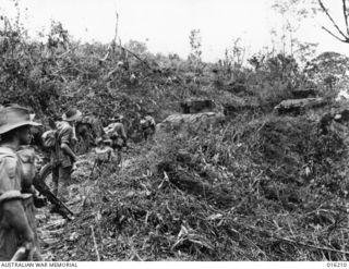NEW GUINEA. 1943-11-27. AUSTRALIAN TROOPS MOVED IN BEHIND MATILDA TANKS FOR A DAWN ATTACK ON THE JAPANESE HELD VILLAGE OF SATTELBERG. N.B. THIS PICTURE WAS TAKEN DURING THE ACTUAL ATTACK