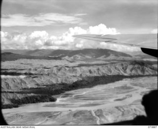 NADZAB, NEW GUINEA. 1944-06-18. AERIAL VIEW OF THE MARKHAM RIVER FROM A UNITED STATES ARMY AIR FORCE LIBERATOR AIRCRAFT, SHOWING LAKE WANUM AND THE KUNAI COVERED MOUNT NGARONENO OPPOSITE NADZAB. ..