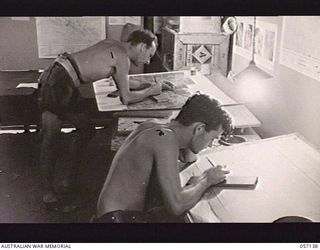 SEVENTEEN MILE, NEW GUINEA. 1943-09-23. NX28952 SAPPER (SPR) W. E. BONNER (LEFT) AND NX120362 SPR N. R. SIMPSON, LITHO ARTISTS OF THE 2/1ST AUSTRALIAN ARMY TOPOGRAPHICAL SURVEY COMPANY, WORKING ON ..