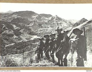 RAMU VALLEY, NEW GUINEA. 1943-11-05. TROOPS OF B COMPANY, 2/27TH AUSTRALIAN BATTALION AT GUY'S POST OVERLOOKING THE FARIA RIVER. THEY ARE, LEFT TO RIGHT: SX2924 CAPTAIN S. J. THOMAS, OFFICER ..