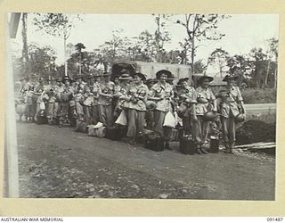 LAE, NEW GUINEA, 1945-05-07. AUSTRALIAN WOMEN'S ARMY SERVICE PERSONNEL FORMING UP OUTSIDE THE GATE OF THE AUSTRALIAN WOMEN'S ARMY SERVICE BARRACKS IN BUTIBUM ROAD. THEY ARE PART OF A GROUP OF 342 ..