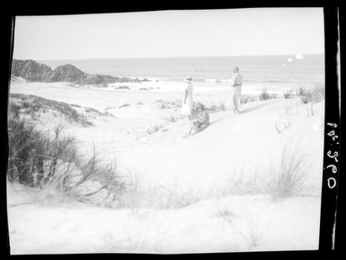 [Three women stand on sand dunes looking toward to the Pacific Ocean - Ocean Beach]