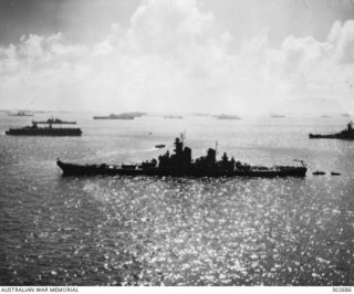 ULITHI ATOLL, CAROLINE ISLANDS. 1944-12-08. SILHOUETTED AGAINST A SPARKLING SEA THE BATTLESHIP USS NEW JERSEY (BB-62) IS THE CENTREPIECE OF AN EXTRAORDINARY CONCENTRATION OF NAVAL POWER WHICH ..