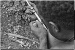 Carving: stone tool being used to smooth an arrow