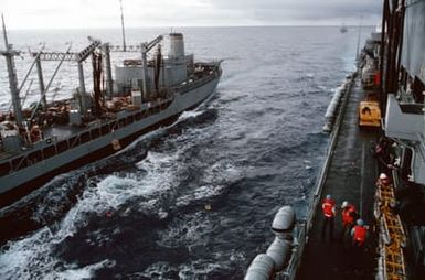 A pallet of supplies is passed on a wire highline rig between the fleet oiler USNS NEOSHO (T-AO 143) and the amphibious assault ship USS SAIPAN (LHA 2) as an underway replenishment is conducted off the coast of Liberia during Operation Sharp Edge. Marines embarked aboard the SAIPAN have been sent to the U.S. Embassy in Monrovia, Liberia, to augment security and evacuate U.S. and foreign nationals from the fighting between government and rebel forces