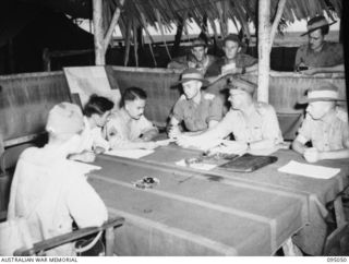 Portrait of Brigadier A R Garrett, BGS, Headquarters 2 Corps (3), interviewing Major Otsu, the Japanese surrender envoy (1), at Headquarters 3 division.  Identified personnel are:- Lieutenant ..