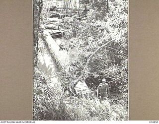 1943-05-17. NEW GUINEA. ORO BAY. THE FOOTBRIDGE AT ORO BAY. THIS WAS CONSTRUCTED FROM STEEL MATTING. (NEGATIVE BY N. BROWN)