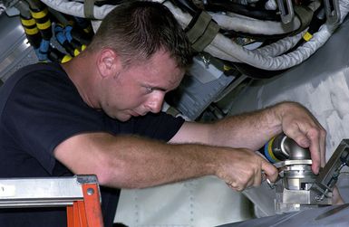 US Air Force (USAF) STAFF Sergeant (SSGT) John Beldin, Weapons Loader, assigned to the 2nd Bomb Wing (BW), installs a Conventional Air Launch Cruise Missile into the weapons bay of a USAF B-52H Stratofortress aircraft while deployed with the 7th Air Expeditionary Wing (AEW) at Andersen Air Force Base (AFB), Guam, during Operation ENDURING FREEDOM