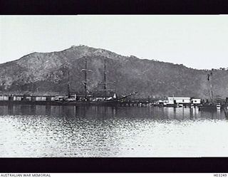 THE AMERICAN BARQUE C. D. BRYANT BERTHED AT A RABAUL WHARF. THE MOUNTAIN IN THE BACKGROUND IS NORTH DAUGHTER