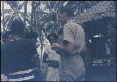 Meeting of village policemen and Patrol Officer, Peter Gall, to explain anti-malaria house-spraying campaign : D'Entrecasteaux Islands, Papua New Guinea, 1956-1959 / Terence and Margaret Spencer