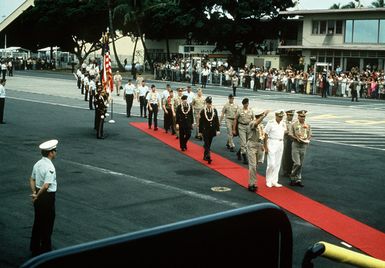 After a brief refueling stop, the first group of Prisoners of War released in Hanoi by North Vietnam walk on the red carpet toward their waiting aircraft. They are lead by Pacific Command's officials and POW, U.S. Navy CPT Jeremiah Andrew Denton, (Captured 18 Jul65). The POWs were enroute from Clark Air Base, Philippines to Travis Air Force Base, CA and then to be reunited with their families in the states