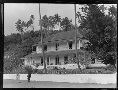 Exterior view of an old two storey house, Rarotonga, Cook Islands, includes a horse on the front lawn