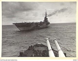 AT SEA OFF RABAUL, NEW BRITAIN. 1945-09-06. THE AIRCRAFT CARRIER HMS GLORY, SEEN FROM THE BOW OF HMS AMETHYST, AFTER THE SURRENDER CEREMONY. THE SURRENDER OF ALL JAPANESE FORCES IN NEW GUINEA, NEW ..