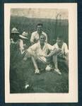 Group of men sitting in field eating sandwhiches, far right is Don Honeysett, New Guinea, c1929 to 1932