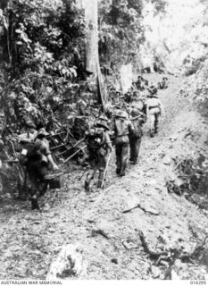 Gusika, Huon Peninsula, New Guinea. 20 December 1943. Australian troops plod up a steep grade north of Gusika, after they had defeated the Japanese there