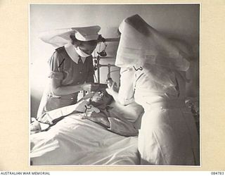 HEIDELBERG, MELBOURNE, VIC. 1945.01.01. CAPTAIN M TISDALL, (1), AND LIEUTENANT J D MONK, (3), AUSTRALIAN ARMY NURSING SERVICE (AANS) SISTERS, AT THE FACIO MAXILLARY AND PLASTIC SURGERY, 115 ..