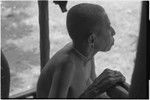 Older woman relaxing on a veranda, in profile