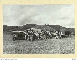 WAU, NEW GUINEA. 1944-04-25. AIRCREW FROM NO.1 COMMUNICATION UNIT, RAAF, WITH MEMBERS OF THE OFFICIAL PARTY ACCOMPANYING THE HONOURABLE E.J. WARD, ON THE PORT SIDE OF THEIR LOCKHEED HUDSON AIRCRAFT ..