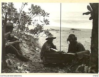 DANMAP RIVER AREA, NEW GUINEA. 1945-01-02. SIGNALLERS OF THE 2/11TH INFANTRY BATTALION REPORTING THE PROGRESS OF THE AUSTRALIAN ATTACK ON JAPANESE POSITIONS ON A HILL FEATURE BEYOND MATAPAU. ..