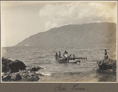 Cape Frere [woman seated on chair being taken out in boat on the water] Frank Hurley