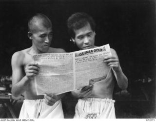 HELDSBACH PLANTATION, NEW GUINEA. 1944-04-06. JAPANESE PRISONERS OF WAR AT THE 106TH CASUALTY CLEARING STATION WHO CAN READ ENGLISH SPEND MUCH OF THEIR TIME IMPROVING THEIR KNOWLEDGE OF THE ..