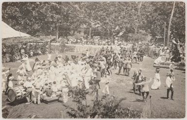Cook Islanders dressed in white and in military uniforms performing