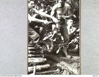 SHAGGY RIDGE, NEW GUINEA. 1943-12-27. MEMBERS OF A 3 INCH MORTAR CREW OF THE 2/16TH AUSTRALIAN INFANTRY BATTALION, 21ST AUSTRALIAN INFANTRY BRIGADE IN ACTION BOMBARDING THE "PIMPLE" PRIOR TO ..