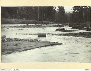 LAE-NADZAB, NEW GUINEA. 1944-07-19. A BADLY FLOODED AND WATER ERODED SECTION OF THE LAE-NADZAB ROAD